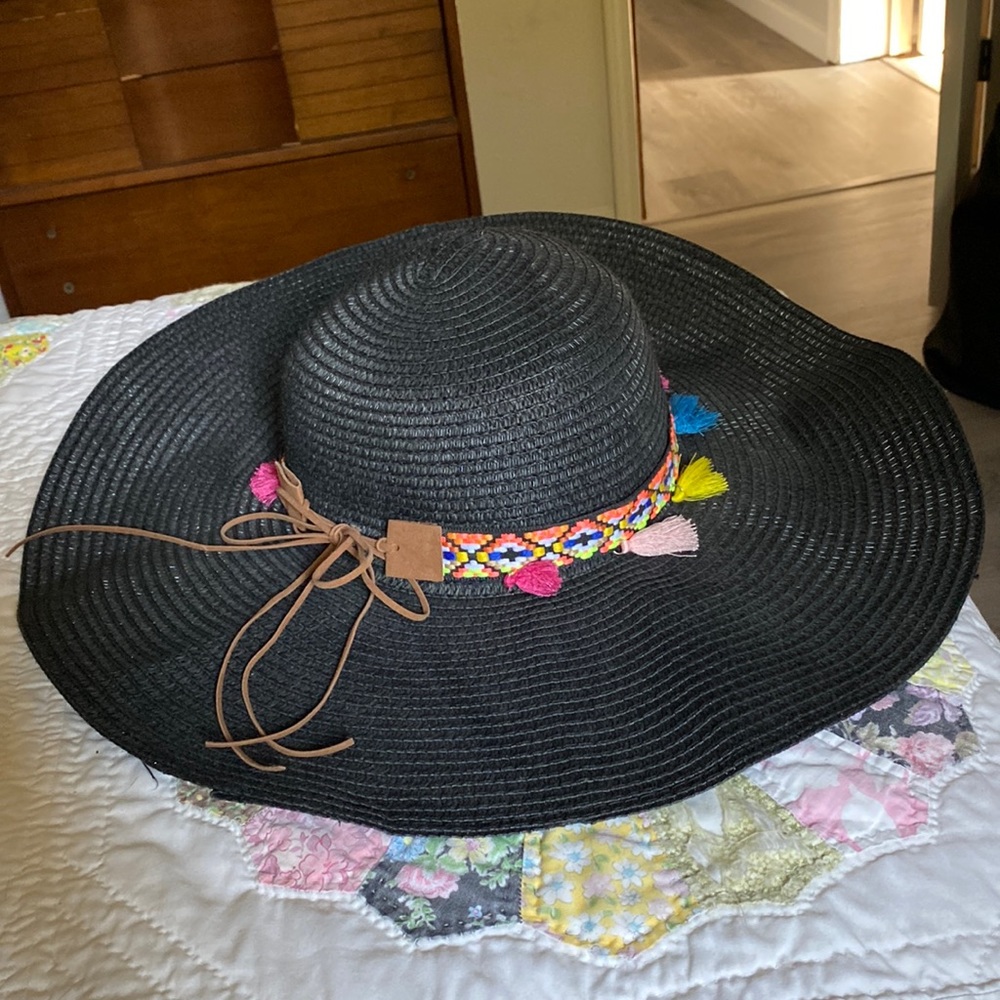 Black beach hat with colorful band and tassels